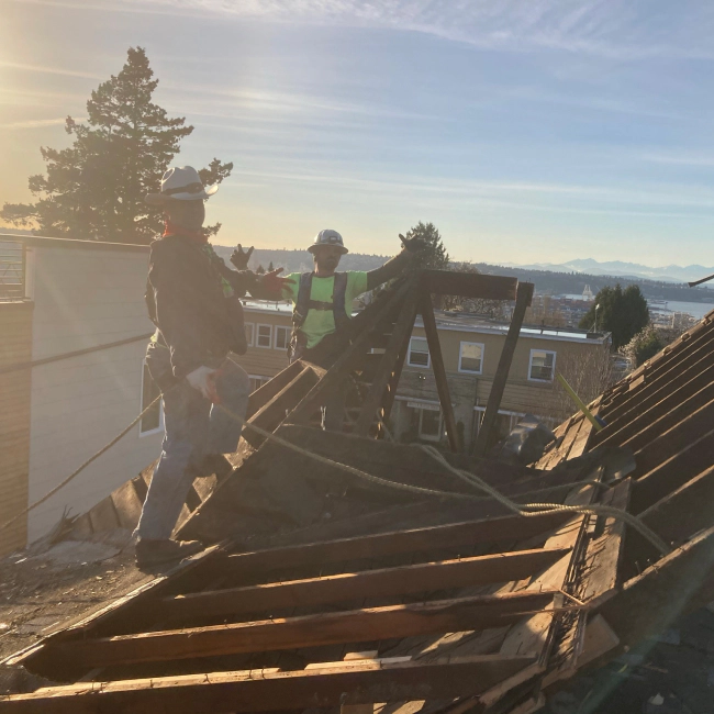 two contractors on top of deconstructed house seattle wa